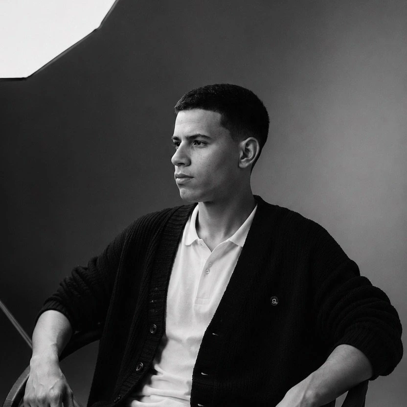 A professional black and white portrait of a filmmaker.